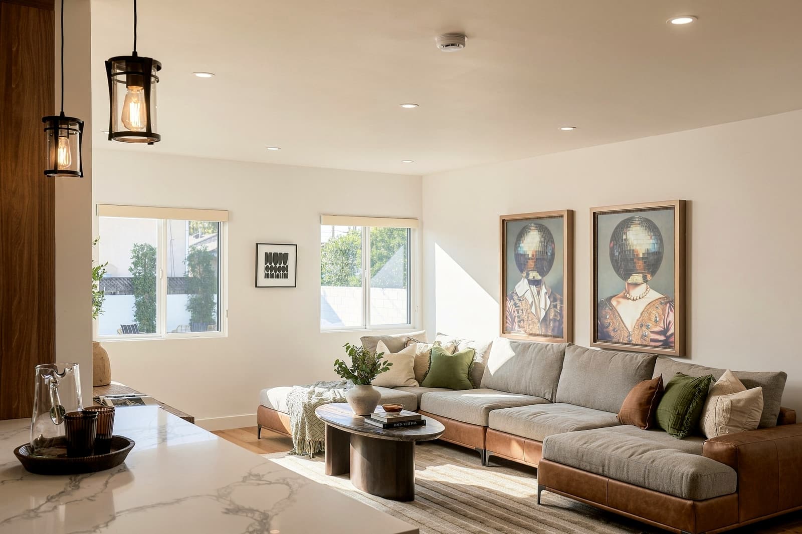 Living room with a sectional and oversized portrait art