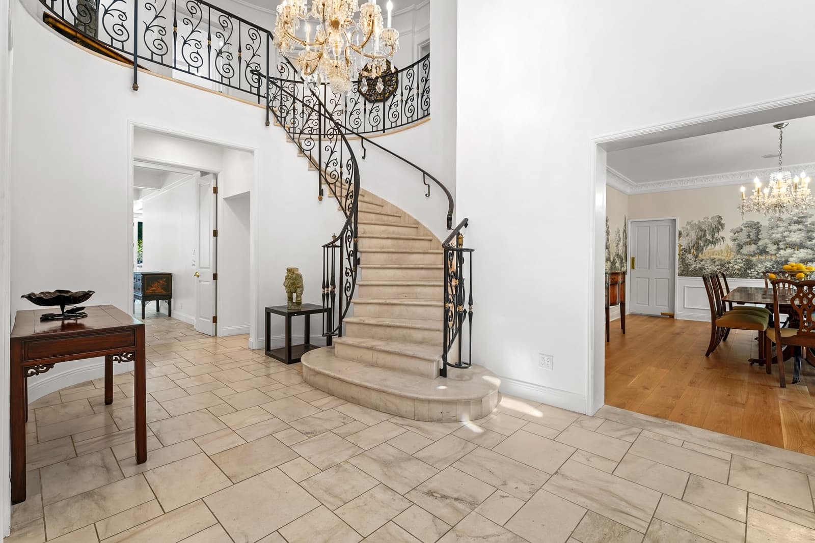 Curved staircase under a crystal chandelier