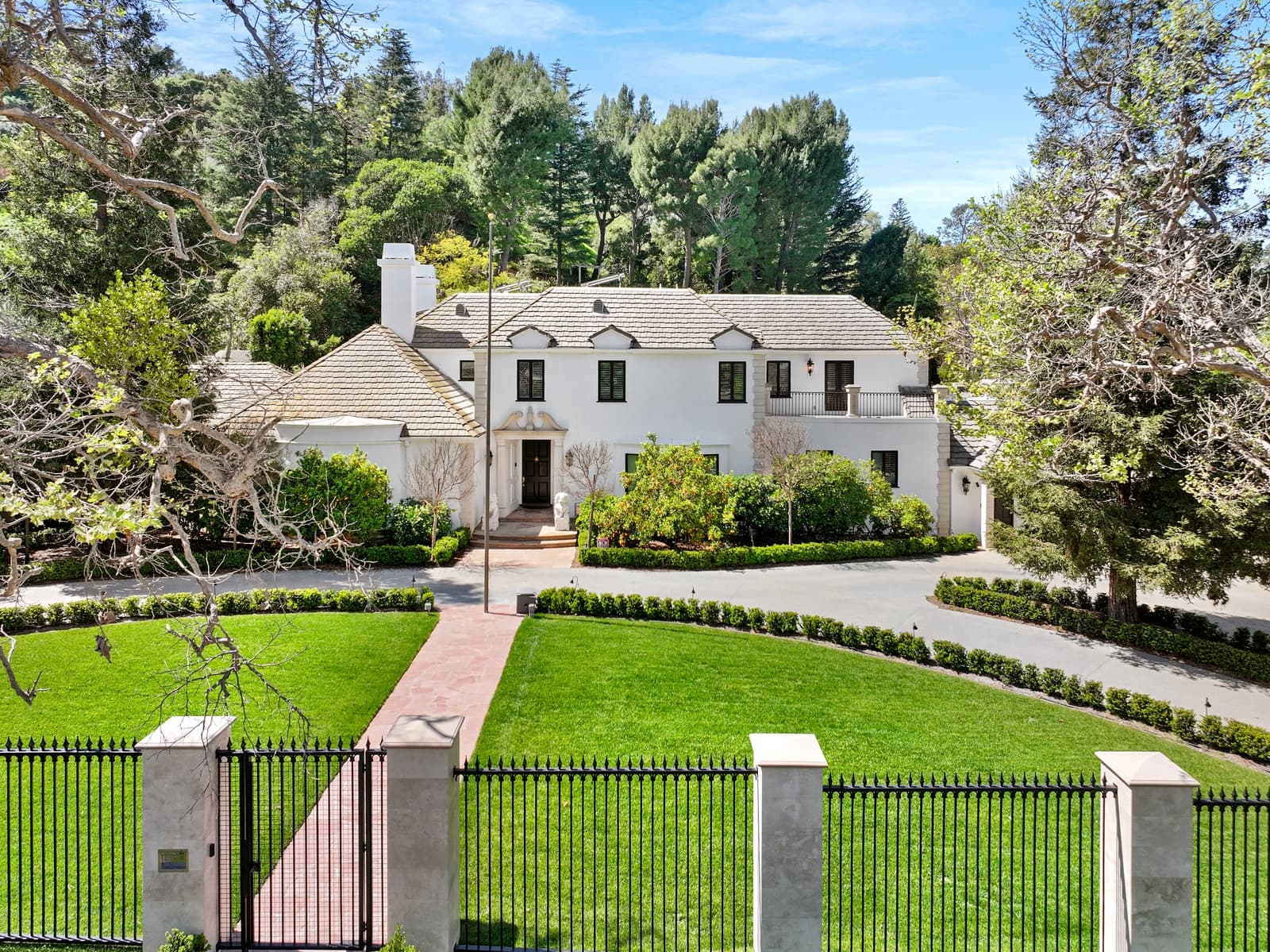 Gated Sherman Oaks estate across a broad front lawn