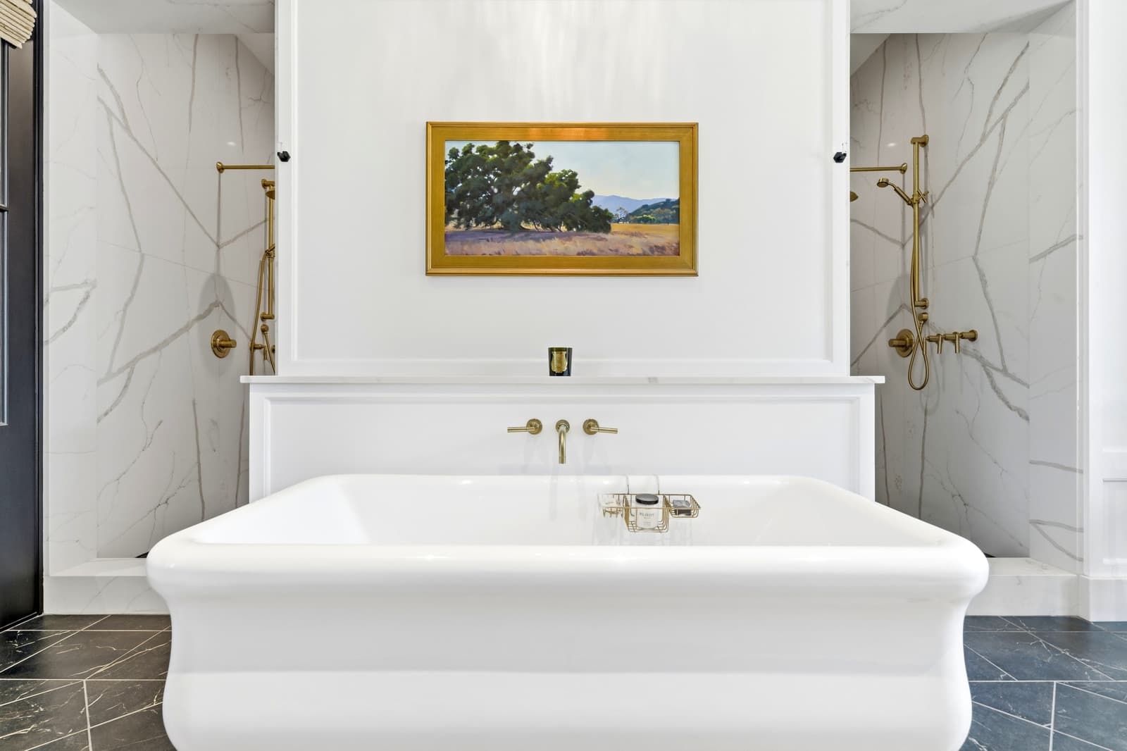 Marble bathroom with a freestanding tub and gold fixtures