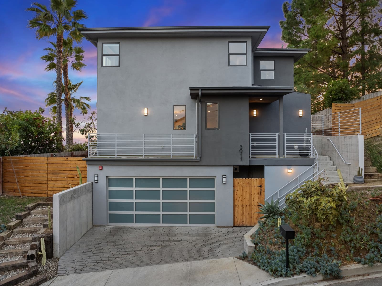 Hillside modern at twilight above the garage