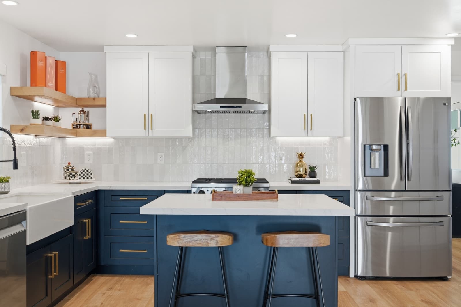 Navy kitchen with white counters and brass hardware
