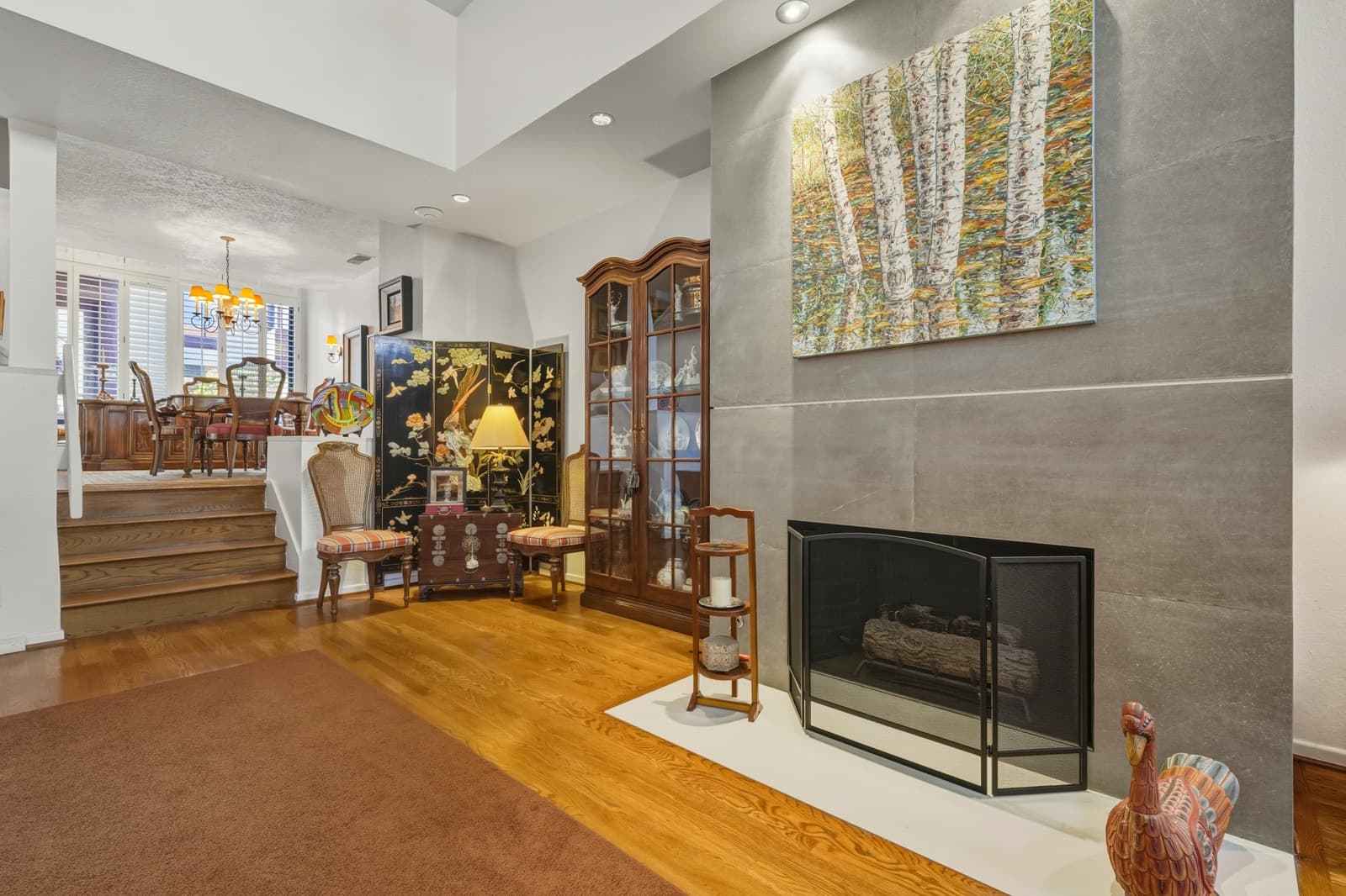 Traditional living room with a fireplace and staircase, photographed by VVT in Pasadena