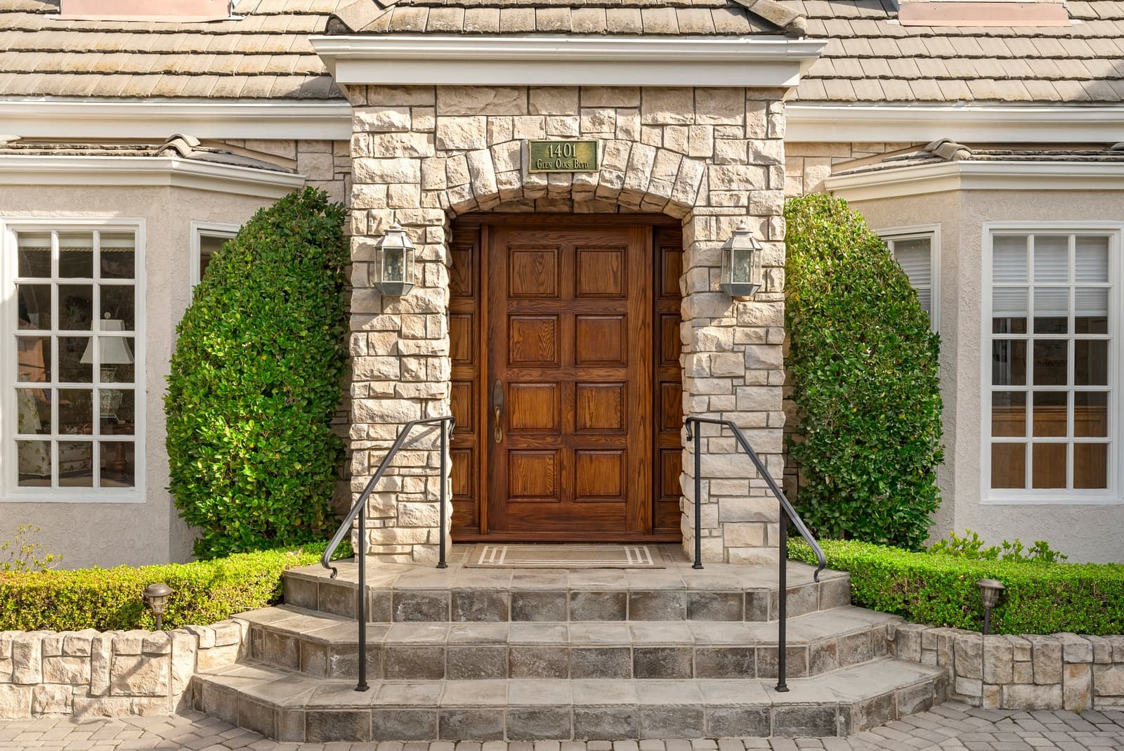 Stone entry with an arched wood door, Pasadena