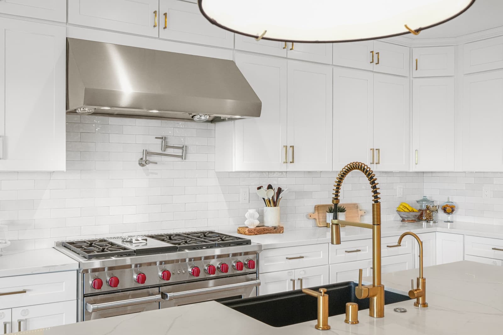 Range with red knobs and a brass faucet
