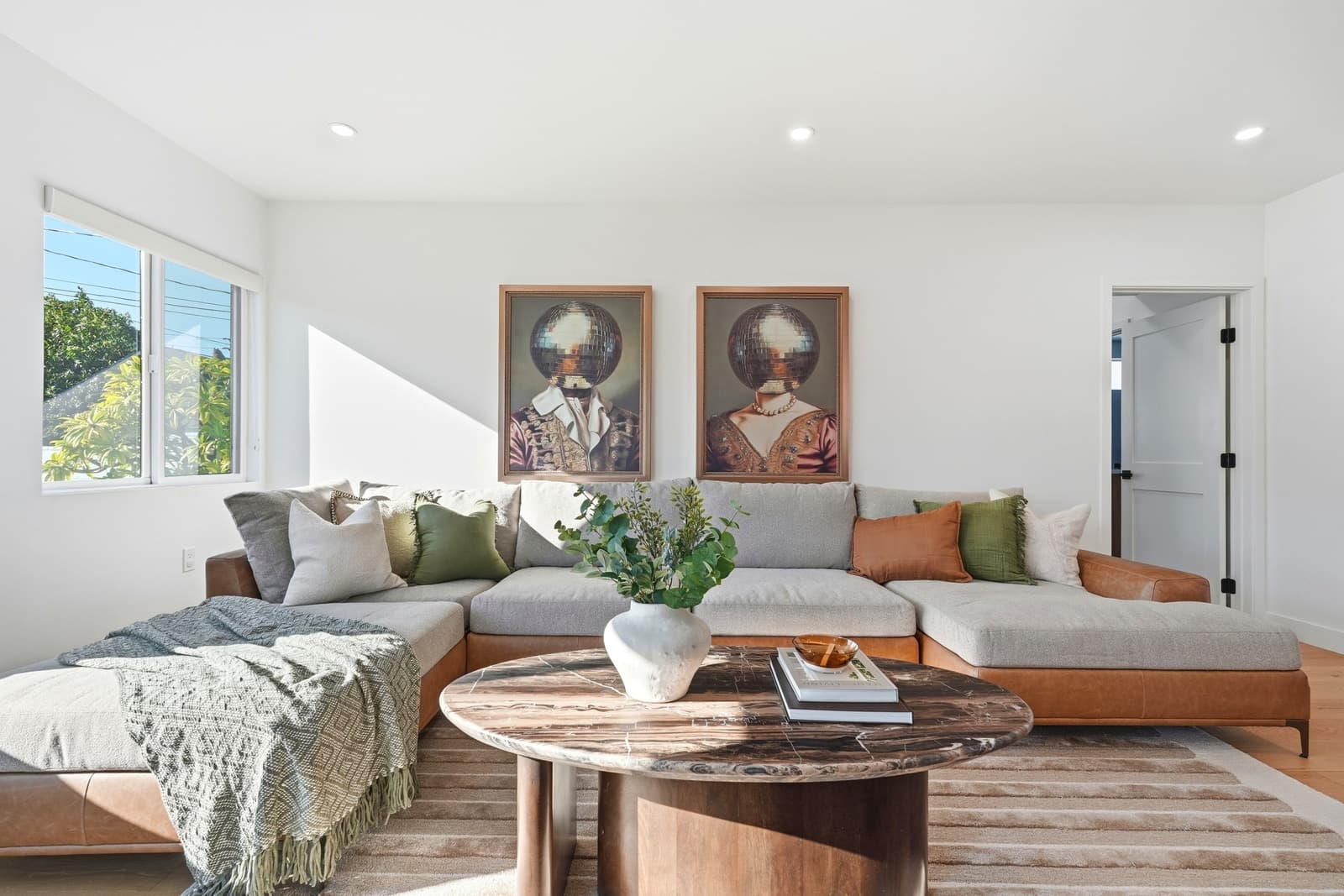 Living room with a wide sectional and framed gallery wall