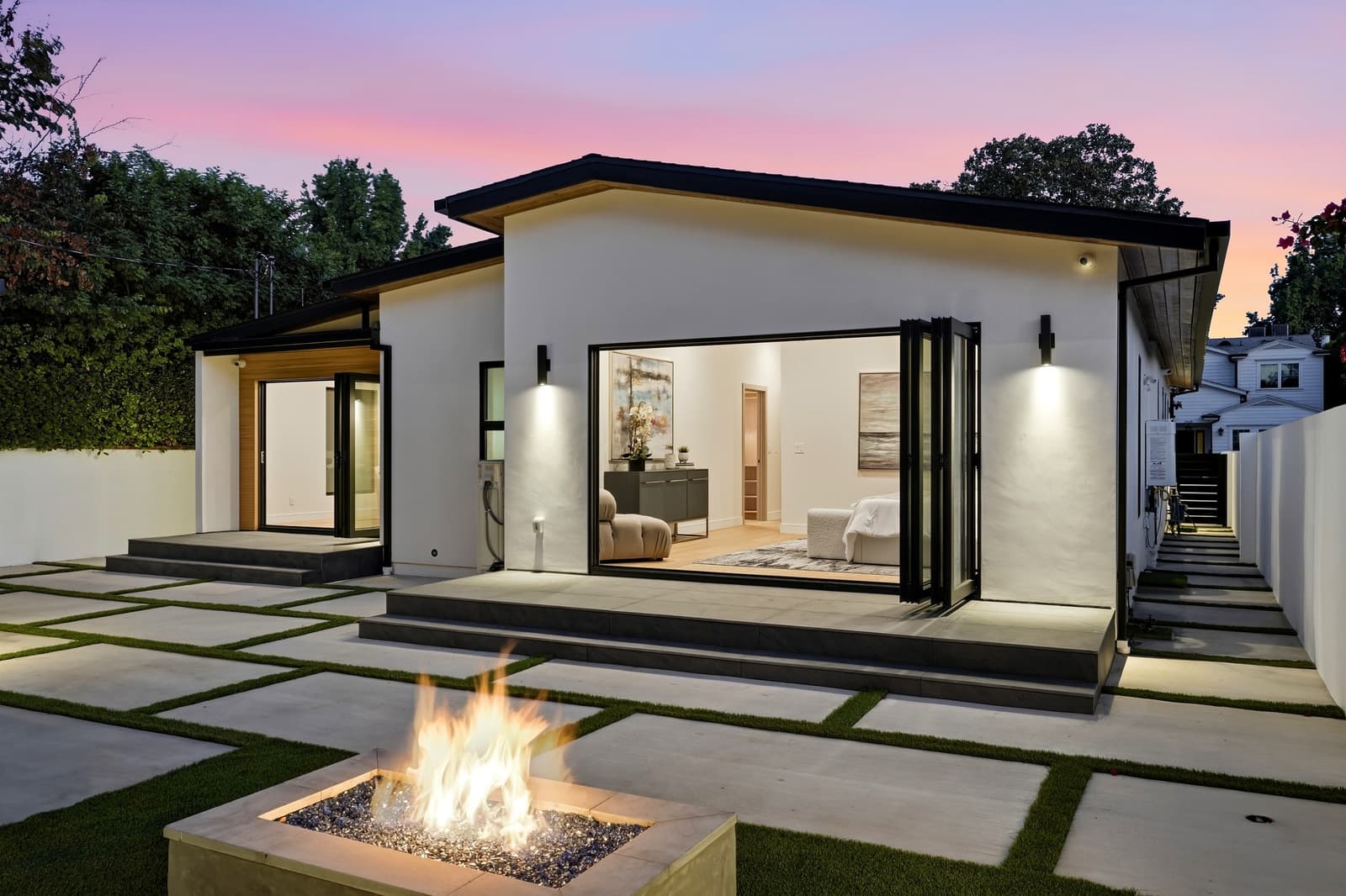 Fire table at night, the glass doors open to the living room