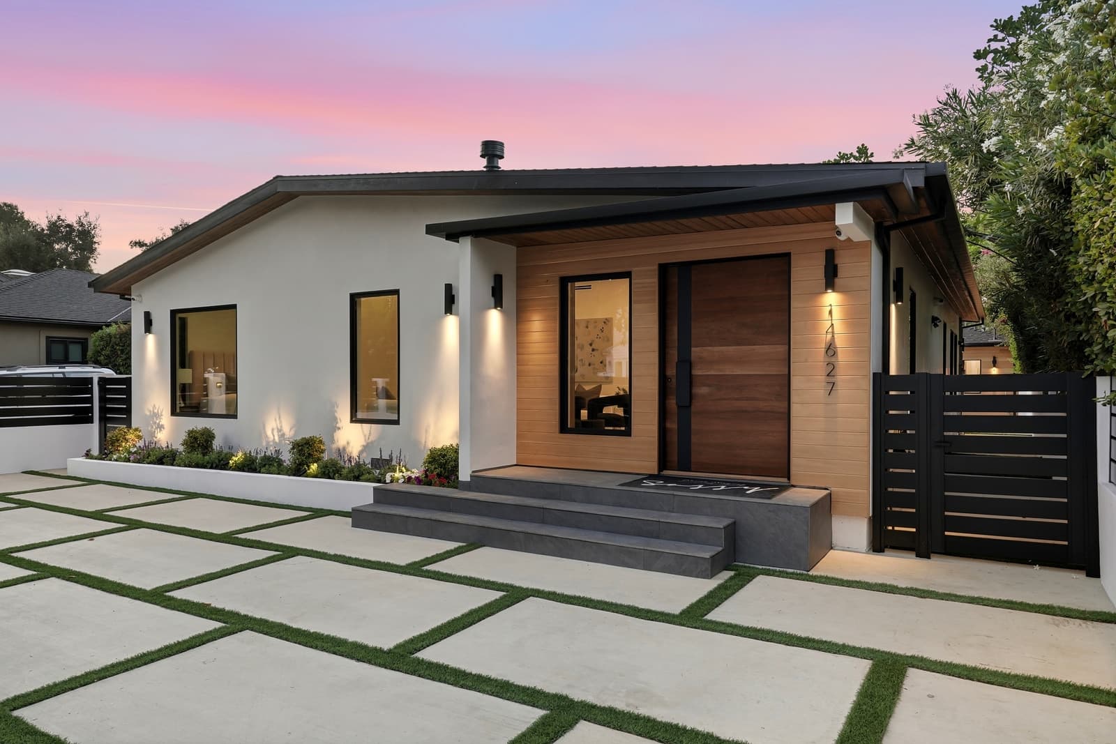 Single-story modern at twilight, pavers and turf leading in, Sherman Oaks