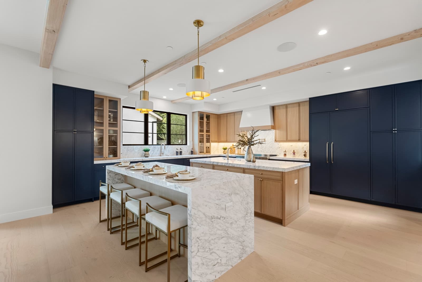 Navy and oak kitchen with brass pendants