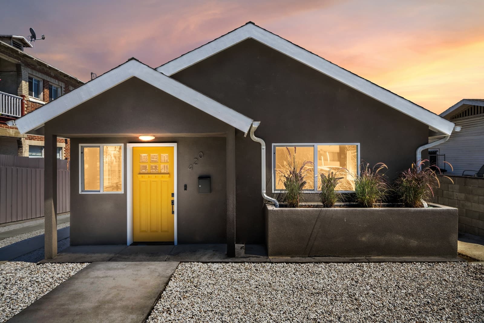 Silver Lake bungalow at twilight, yellow door, sunset sky