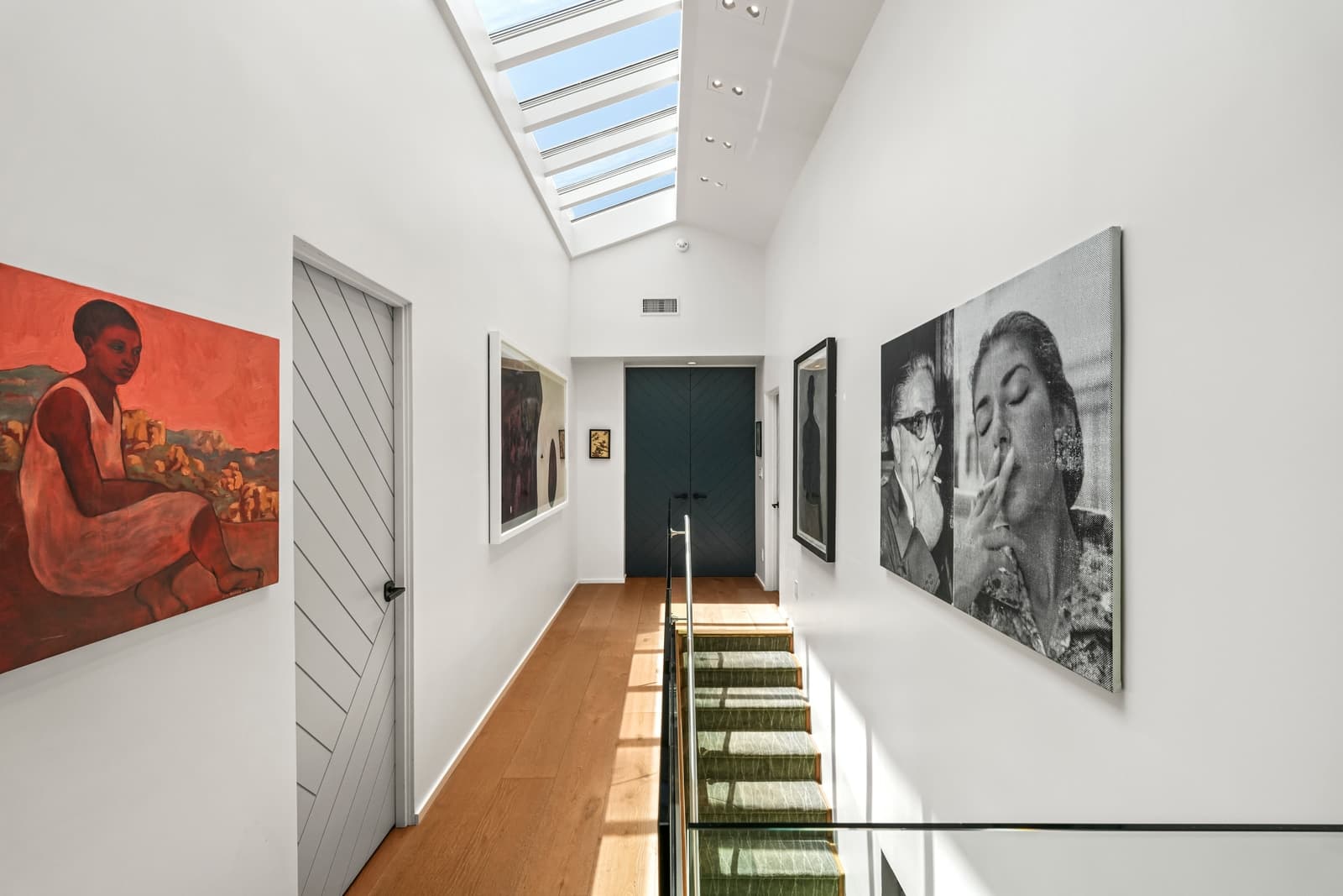 Skylit gallery hallway hung with art
