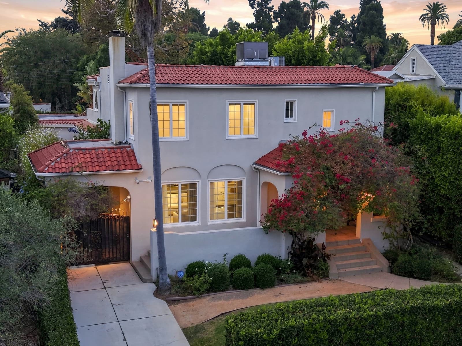 Drone at twilight over a Spanish two-story, red tile roof