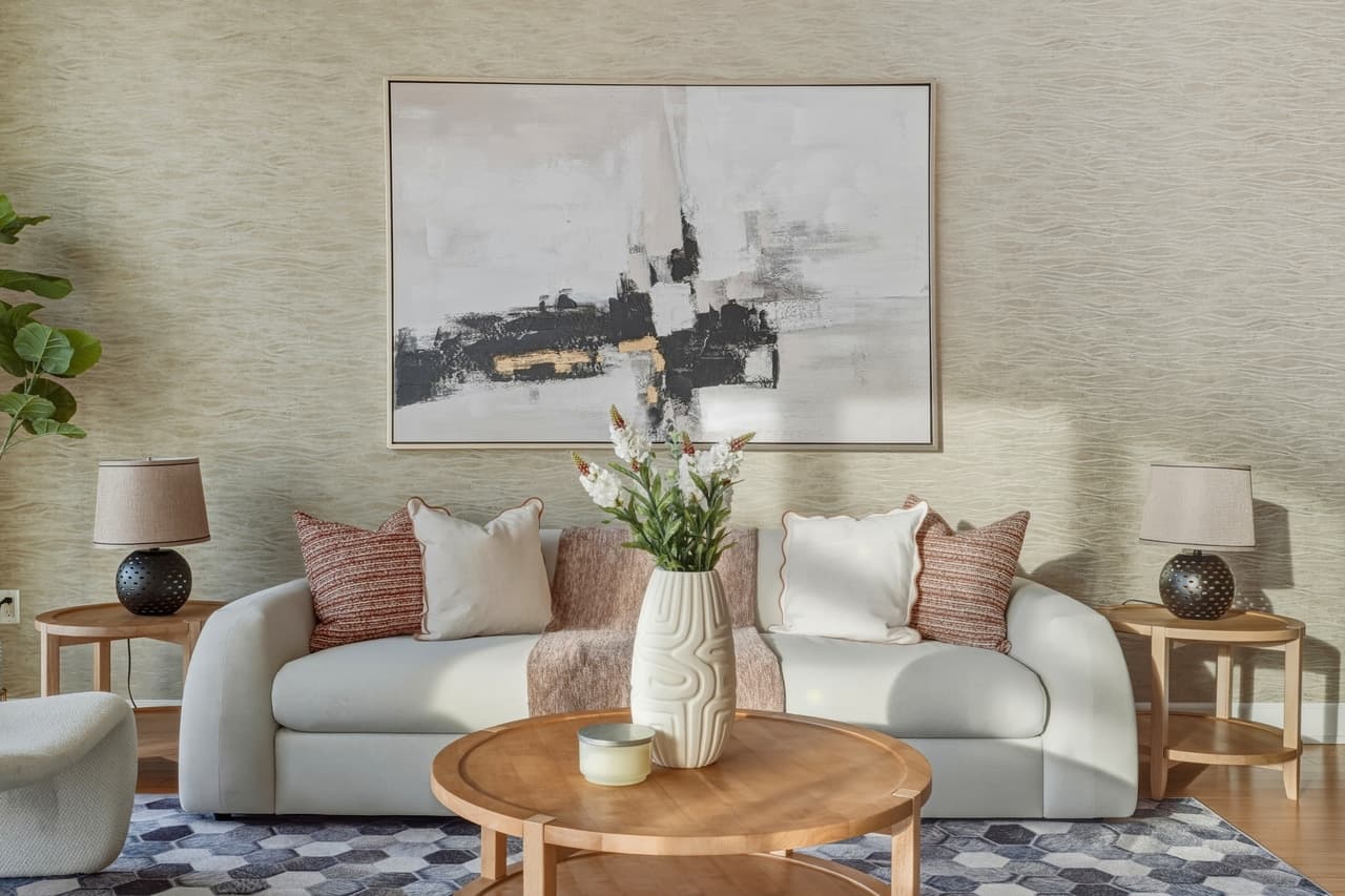 Living room vignette with layered textiles and a round oak table