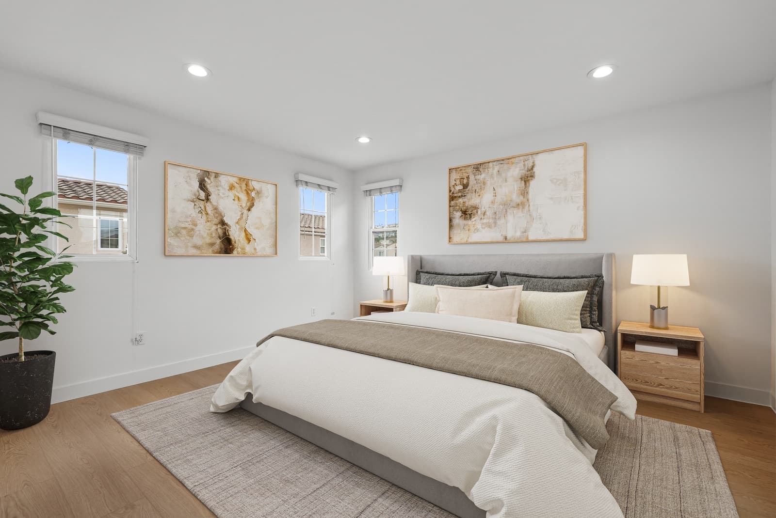 The same bedroom, virtually staged with a bed, nightstands and art