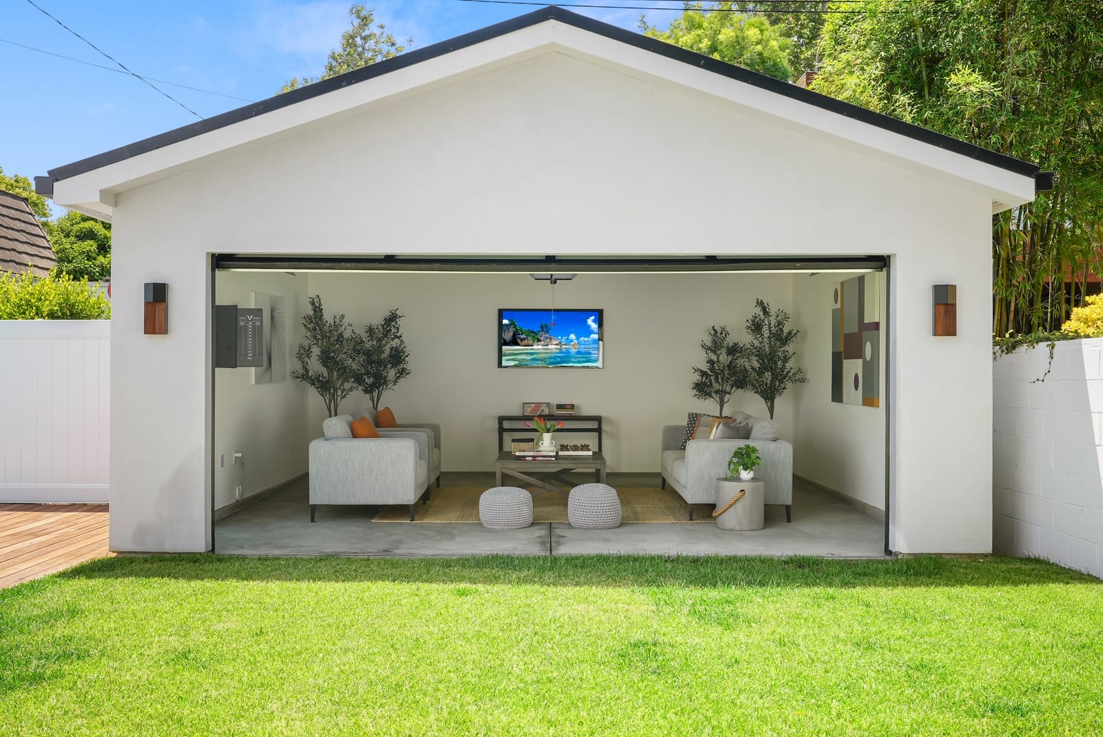 Pool house with its glass door rolled up onto a lounge, seen straight on