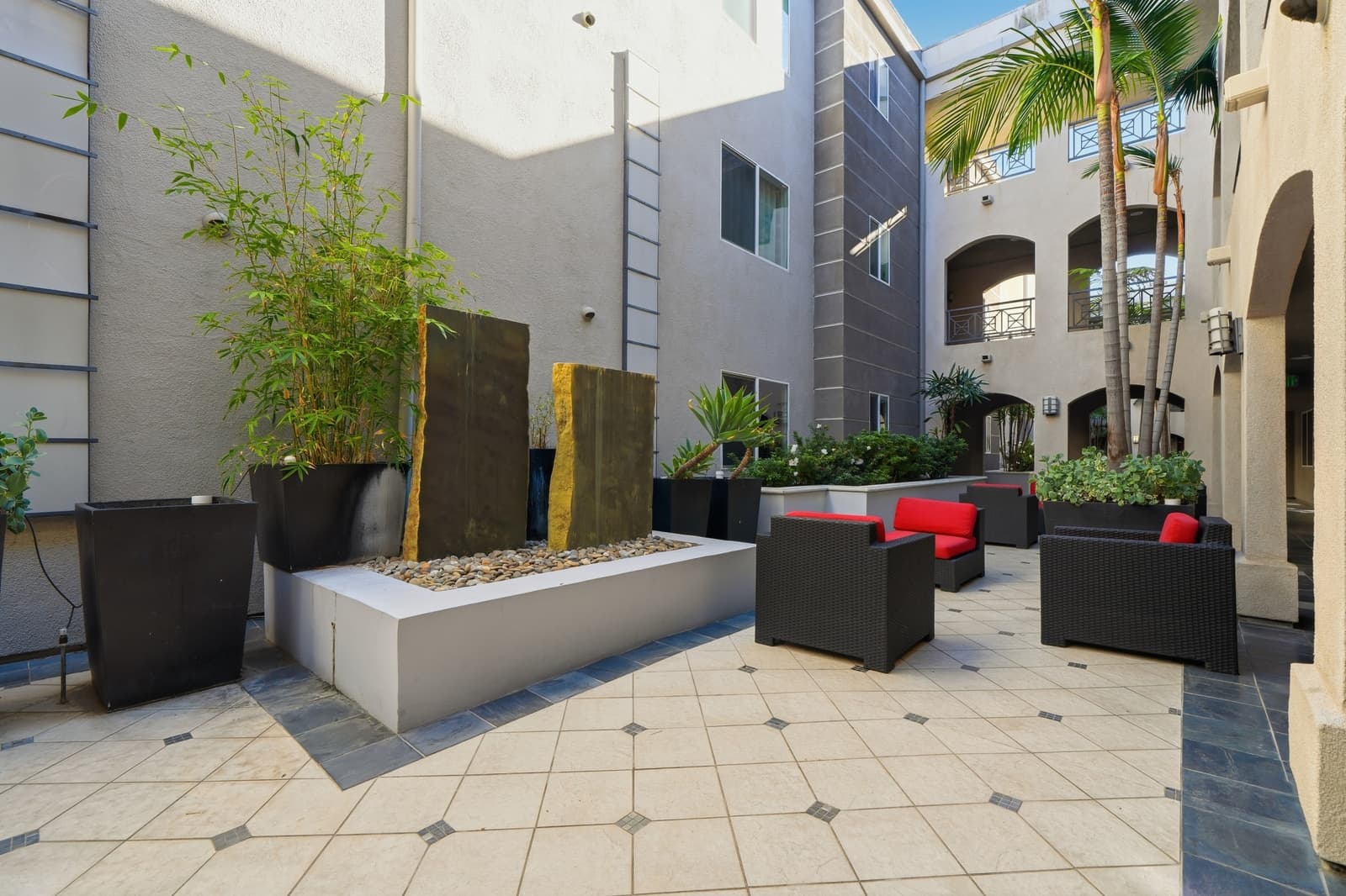 Luxury condo courtyard with a water feature and bamboo, photographed by VVT in Studio City