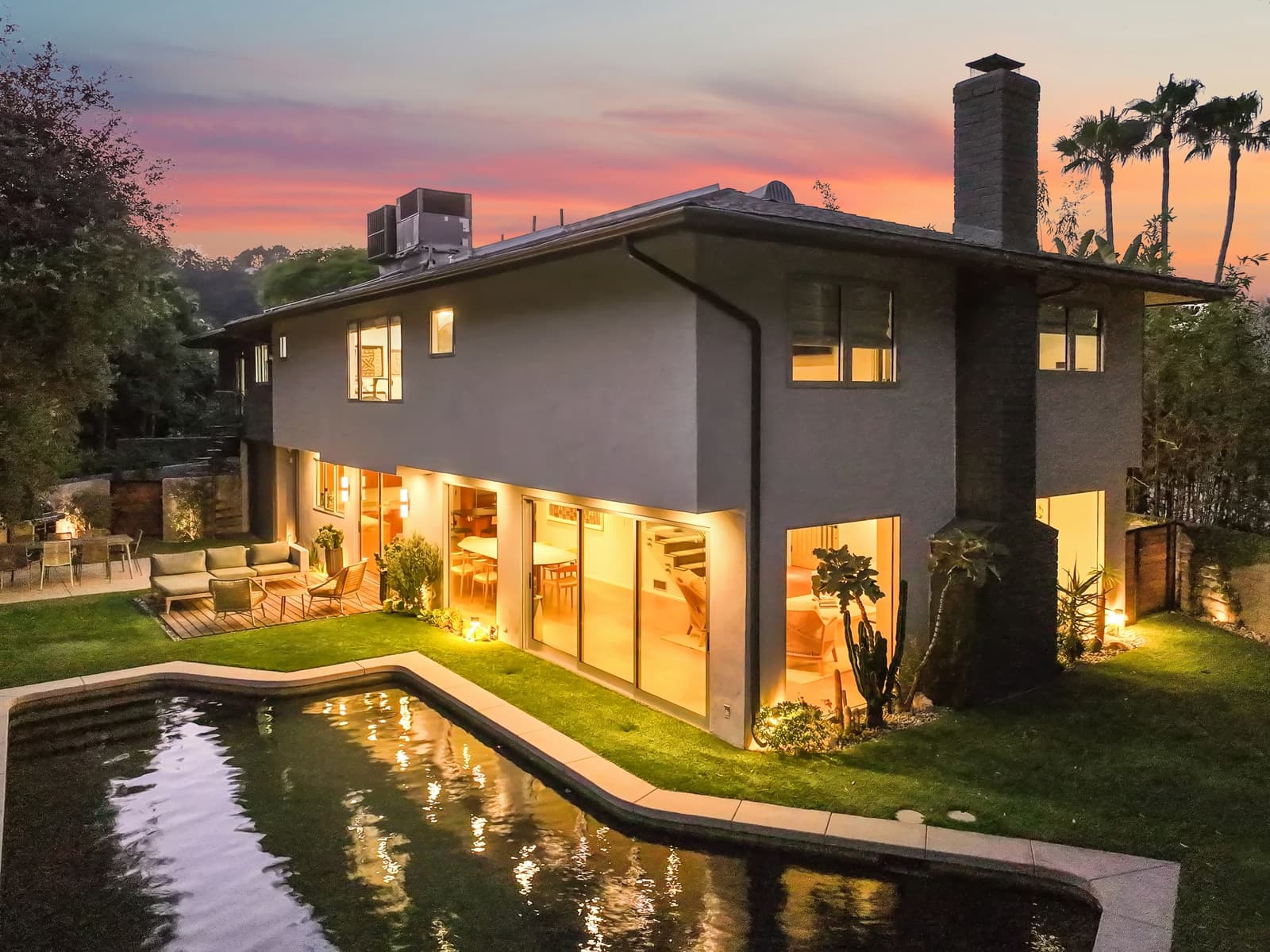 Modern home and pool from above at twilight