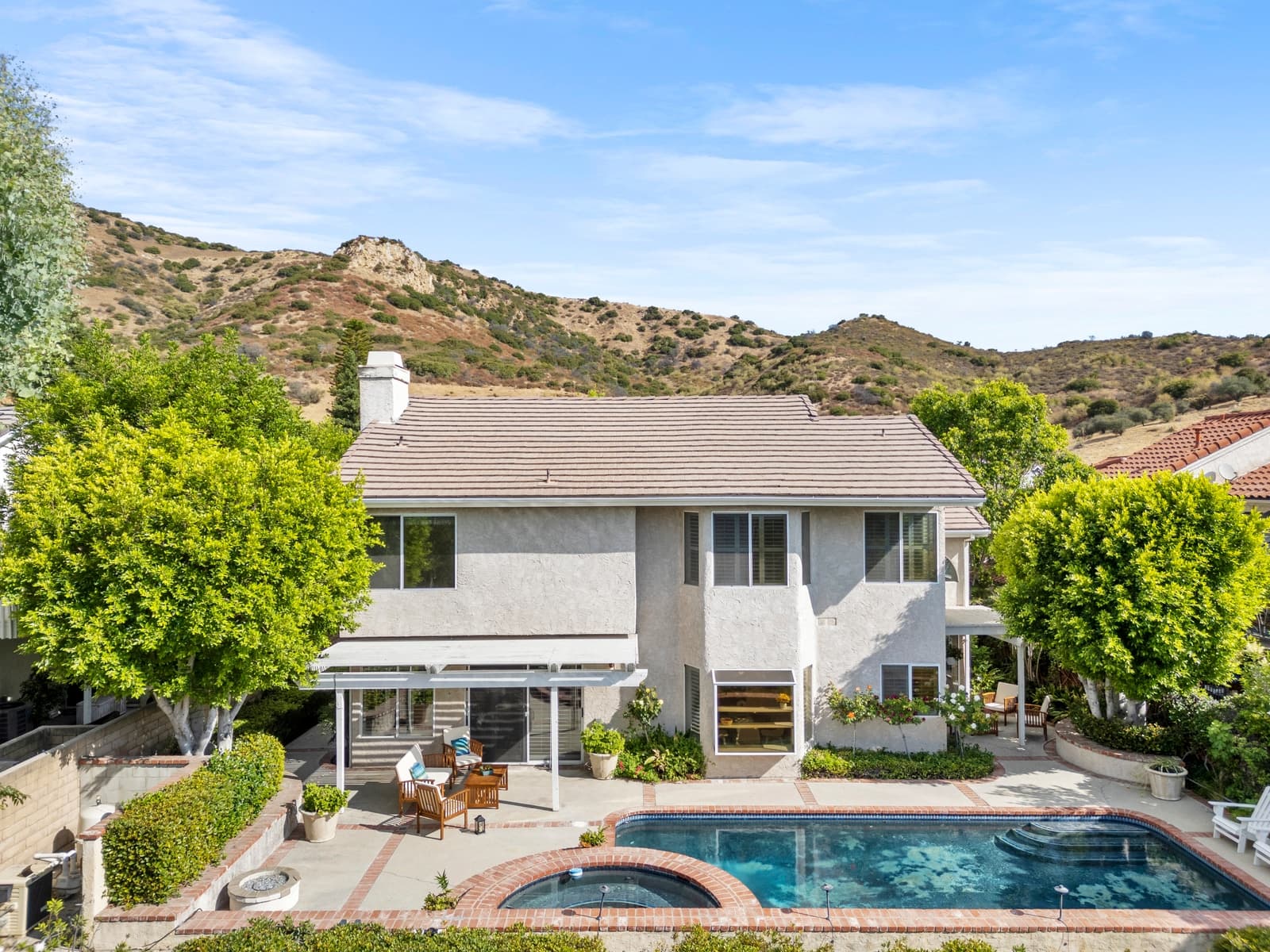 Pool and rear of a two-story at twilight, West Hills