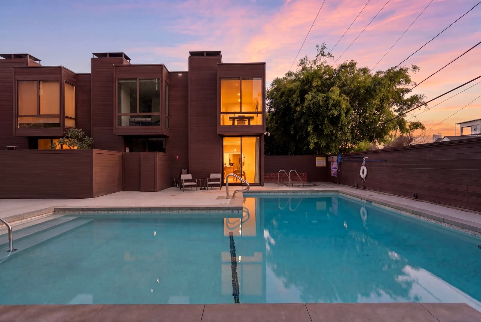 West Hollywood townhomes at twilight around a lit pool