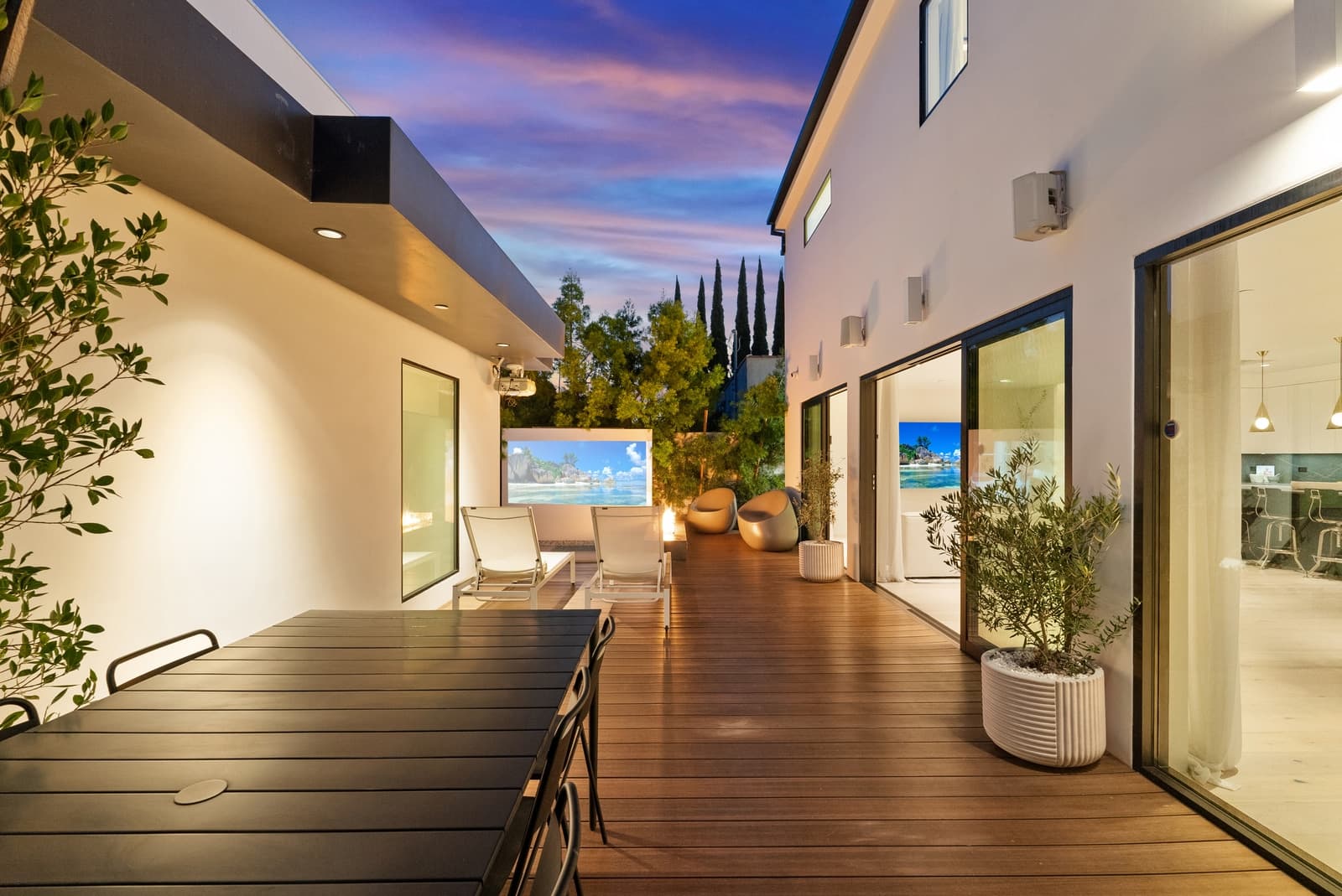 Rear of a modern at twilight, glass wall lit