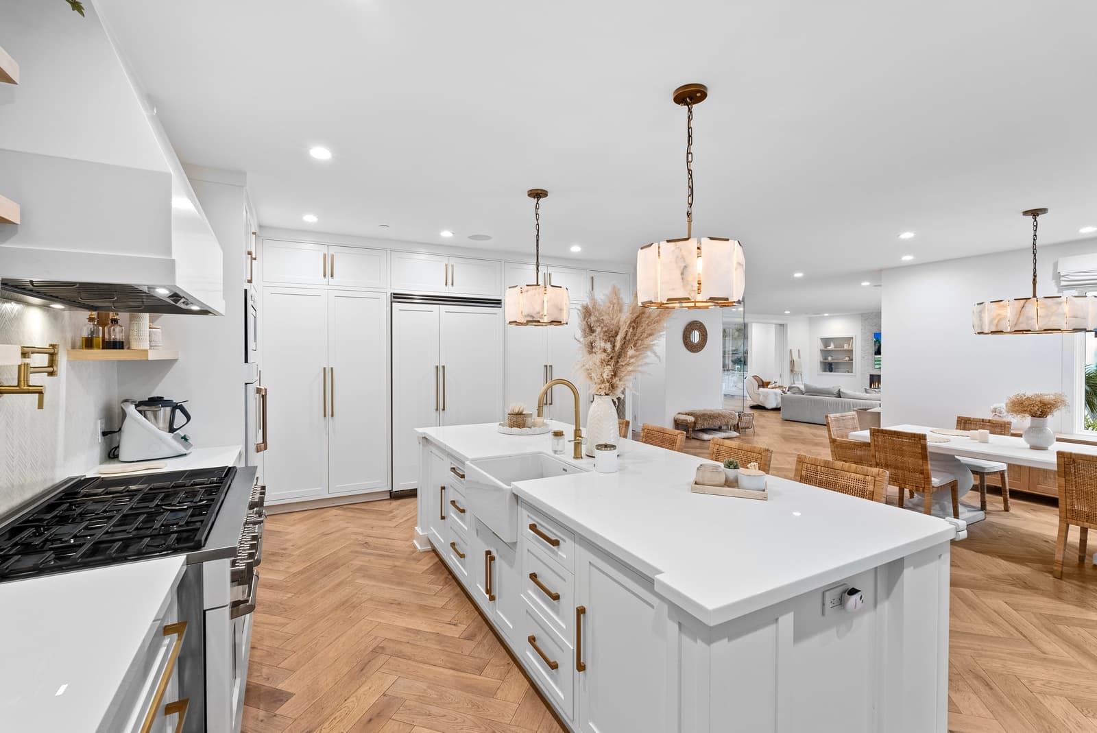White kitchen with an island and pendant lights