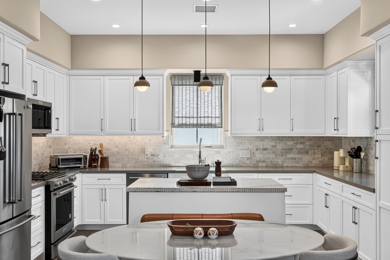 White kitchen with a round island