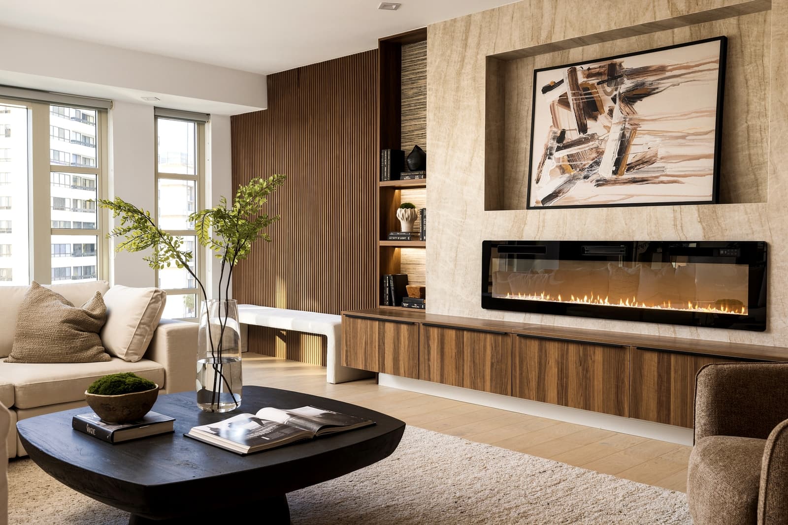 Travertine fireplace wall with a linear fire and art above