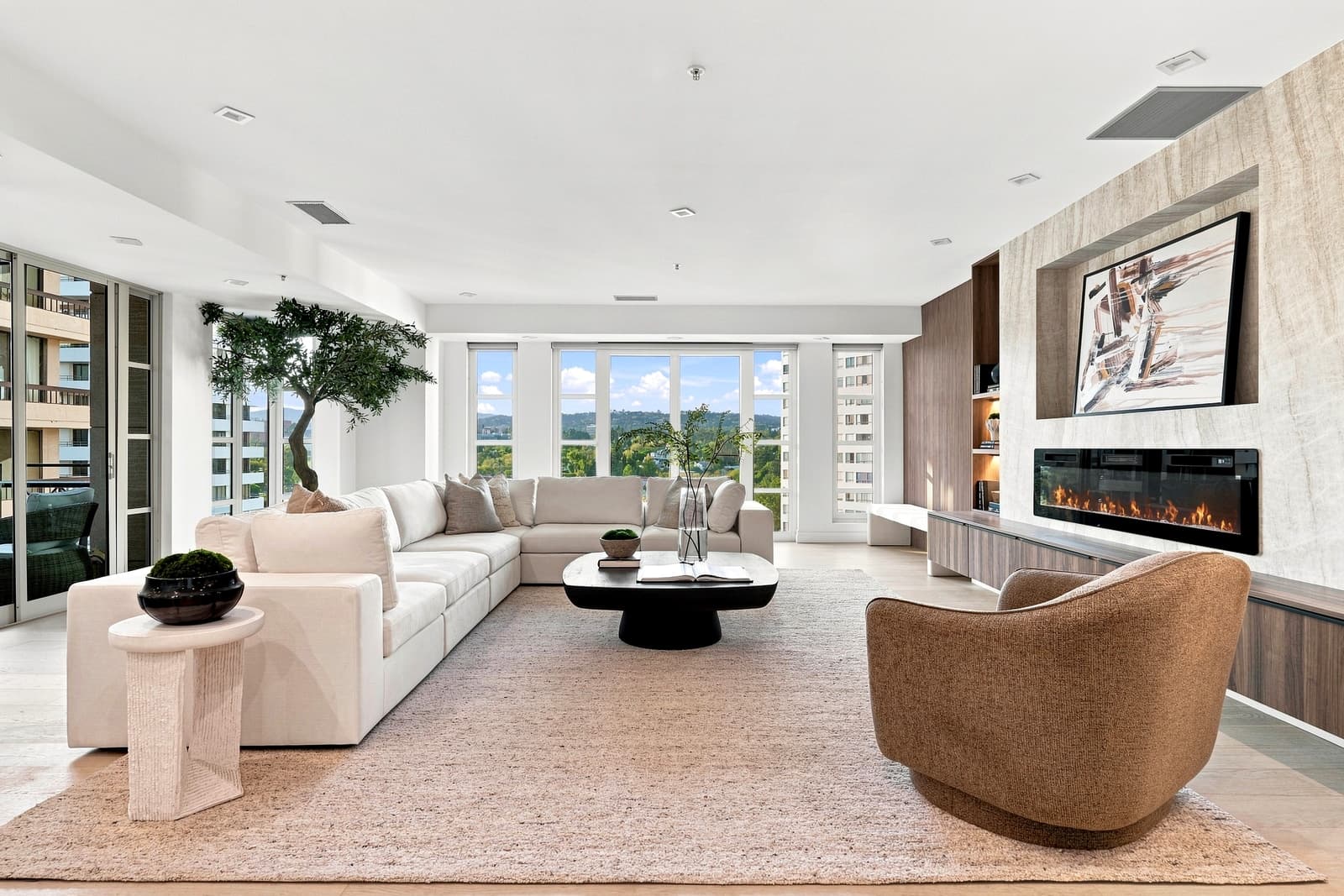 Living room by day, linear fireplace and a wall of windows