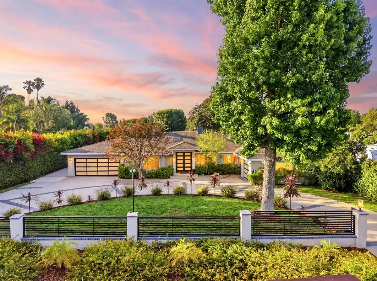Drone view of a Woodland Hills home with a pool and tennis court